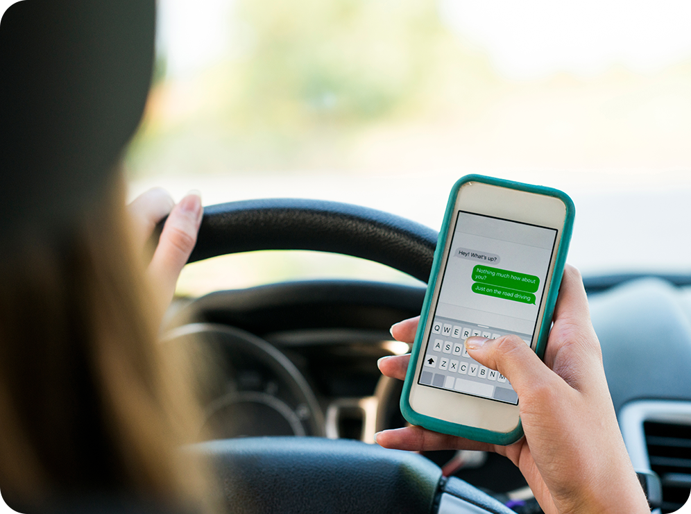 Photo of woman texting and driving