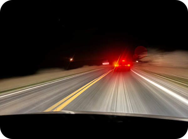 Photo of road ahead at night in motion from a driver's perspective