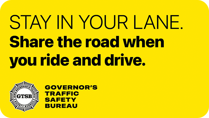 Image that says “Stay in your lane. Share the road when you ride and drive.”