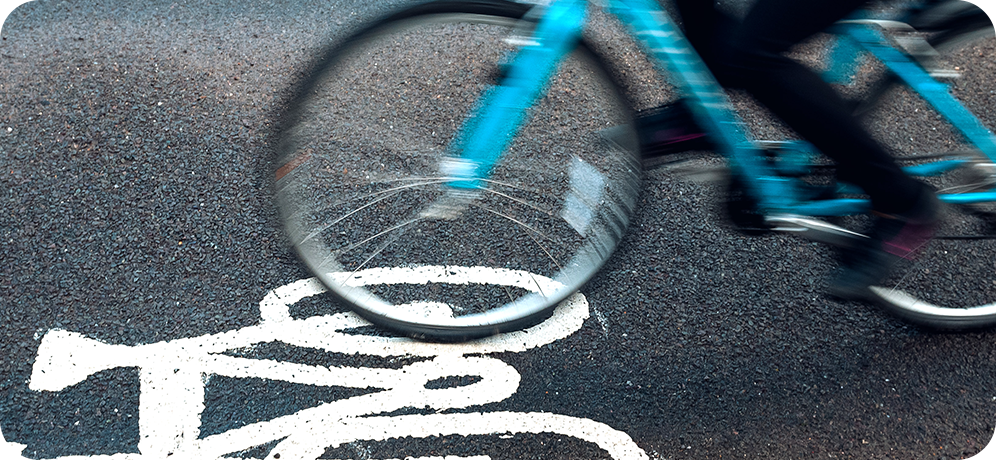 Photo of a bicycle in motion in a bike lane
