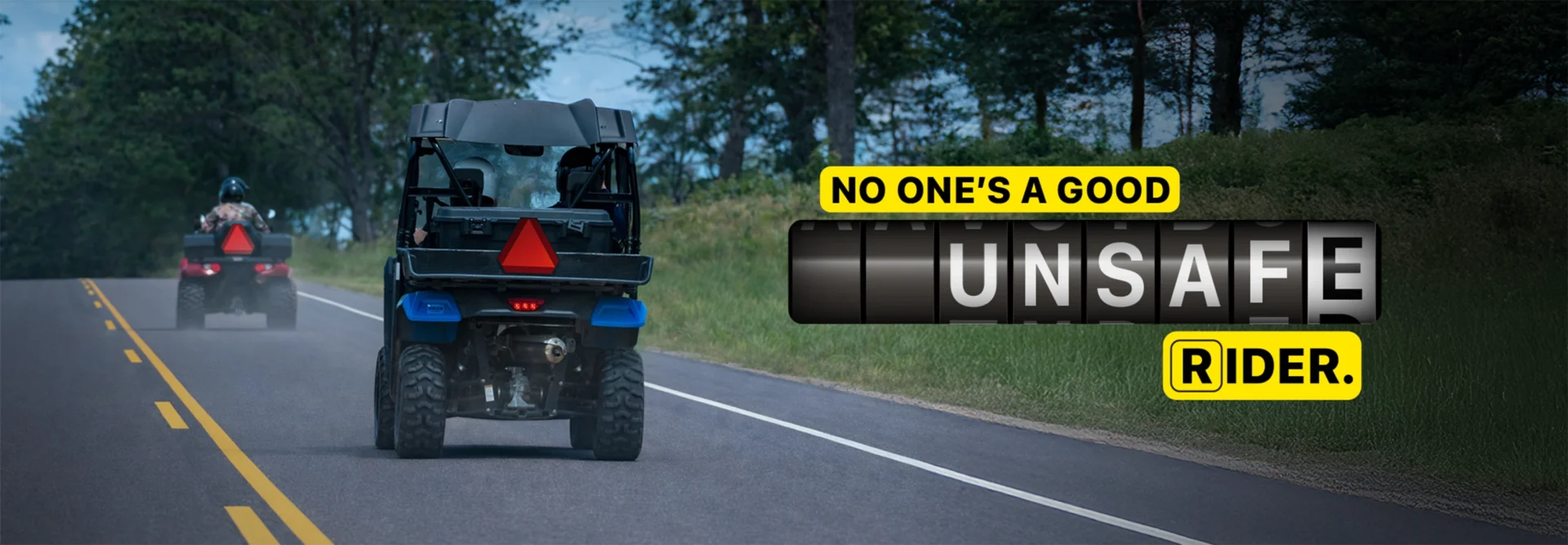Two all-terrain vehicles (ATVs) on a public road with slow-moving vehicle signs and the message "No one's a good unsafe rider," with "unsafe" styled like a speedometer.